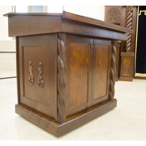 wood bimah with carving and angled table with hand carved wood twists