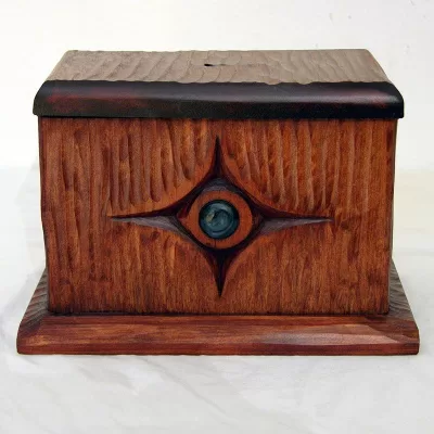 hand carved tzedakah box with texture and glass inlay