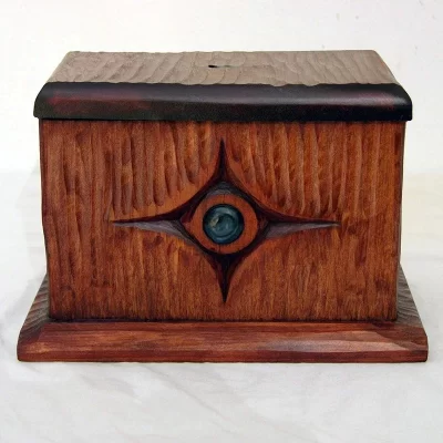 hand carved tzedakah box with texture and glass inlay